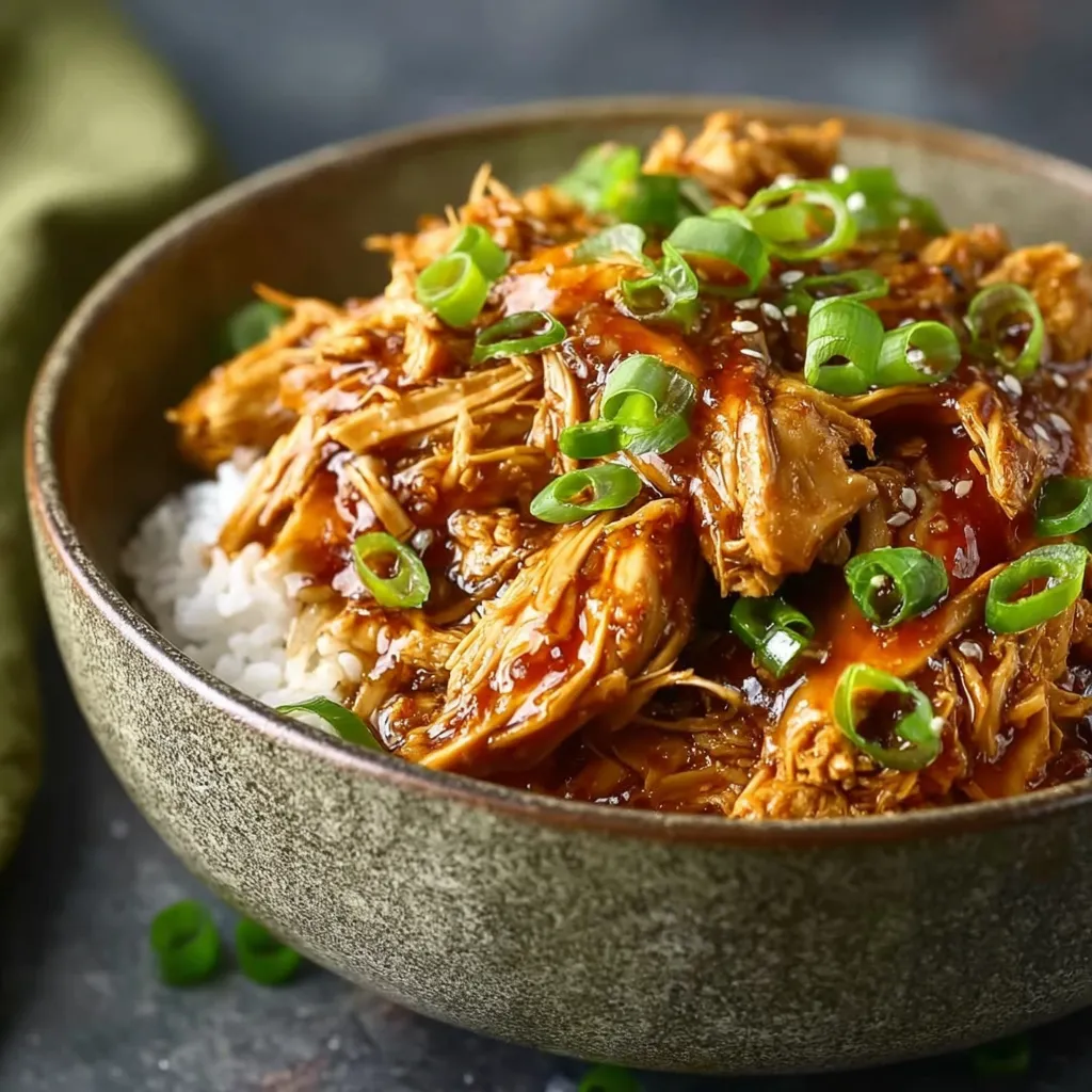 A bowl of meat with rice and vegetables.