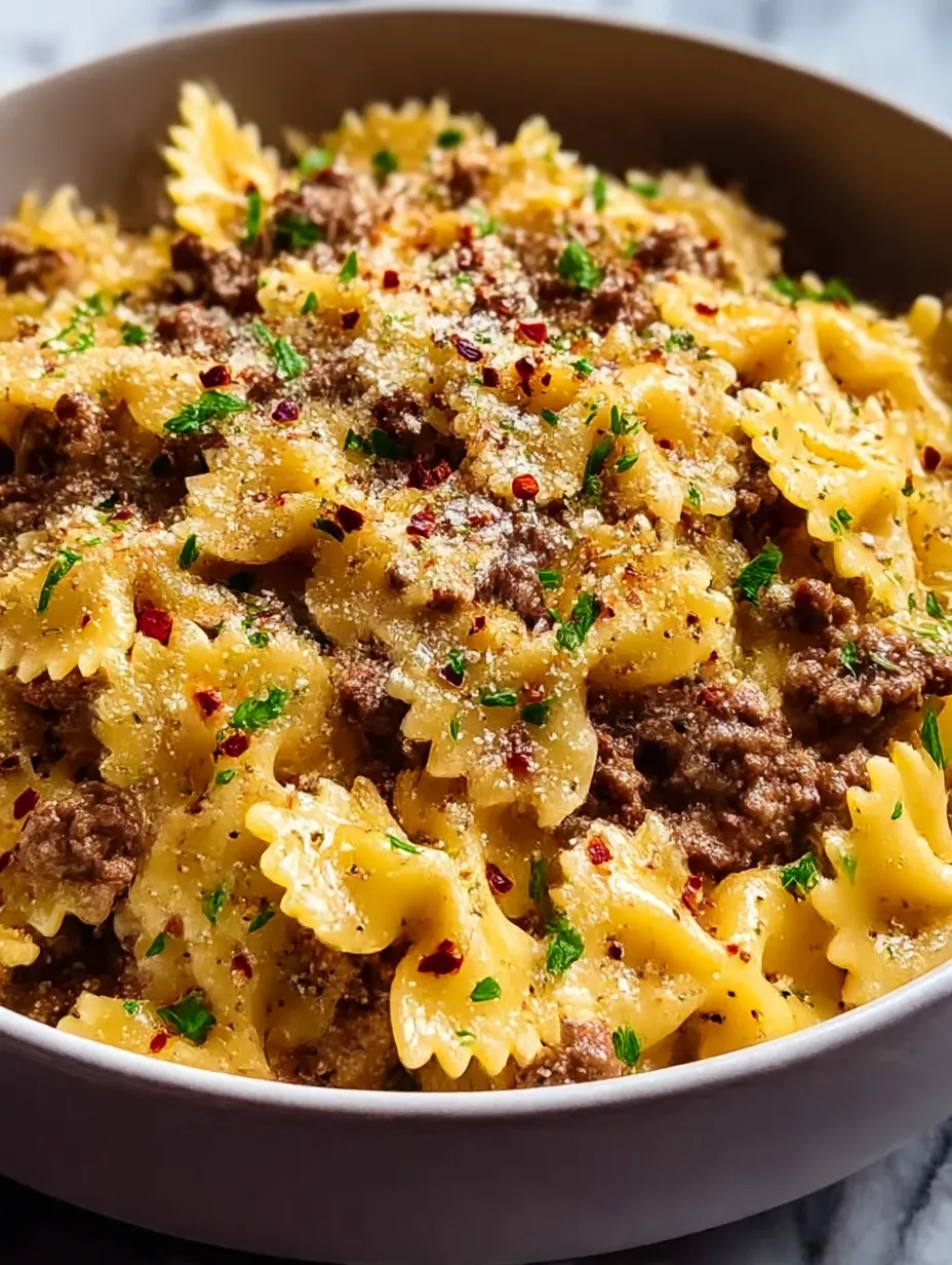 A bowl of pasta with meat and cheese.