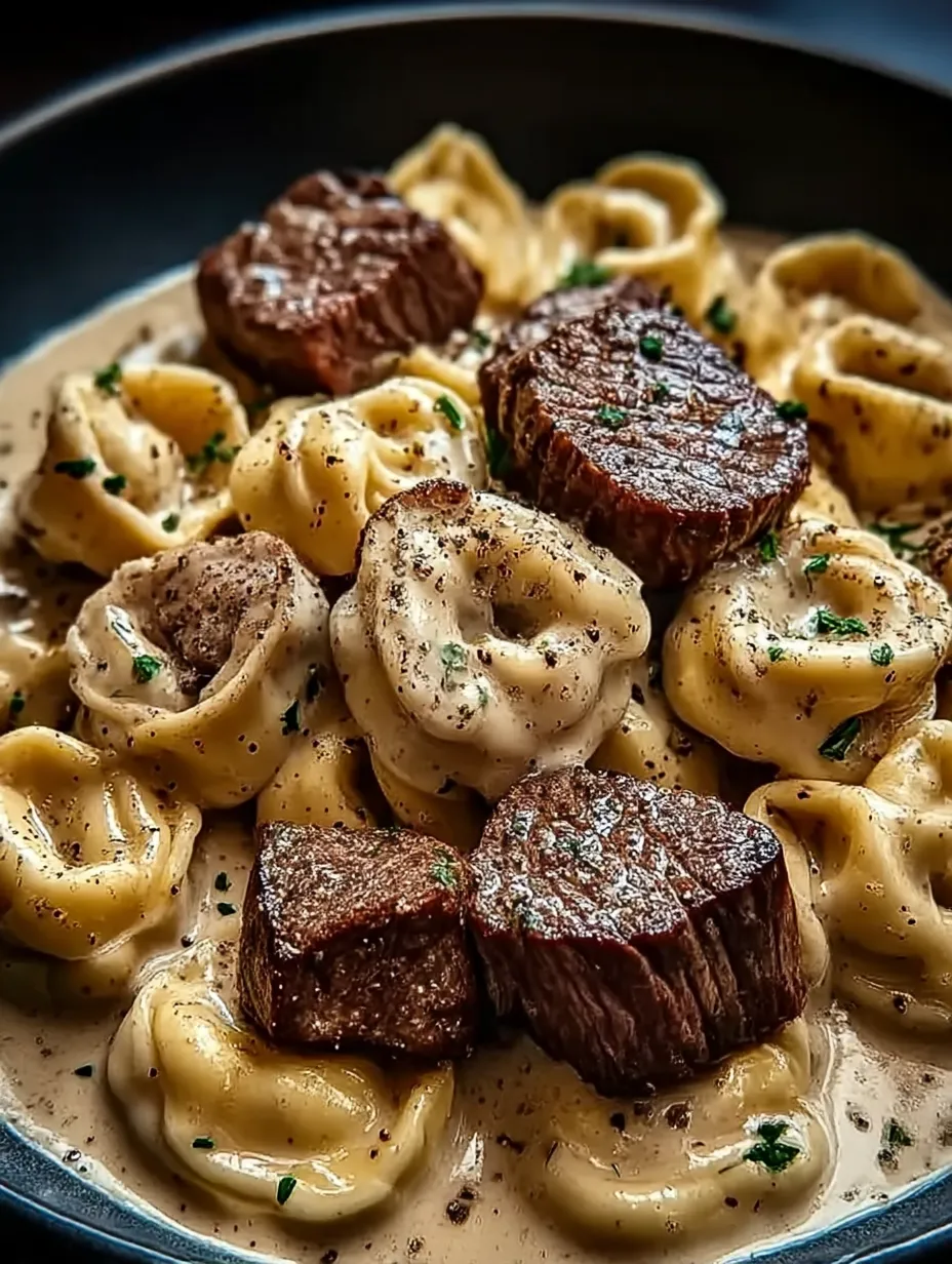 A plate of food with meat and pasta.