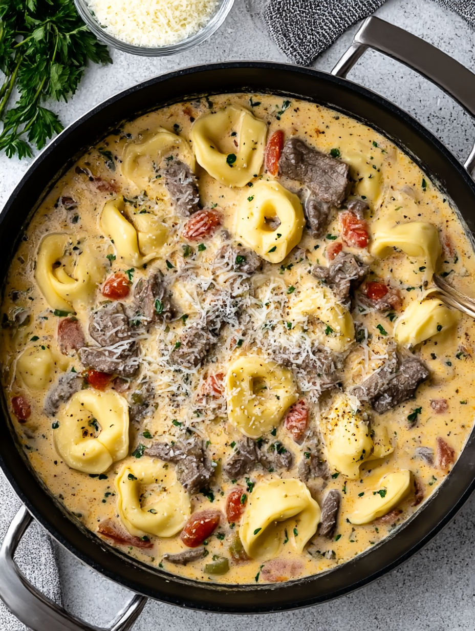 A dish of pasta with meat and tomatoes.