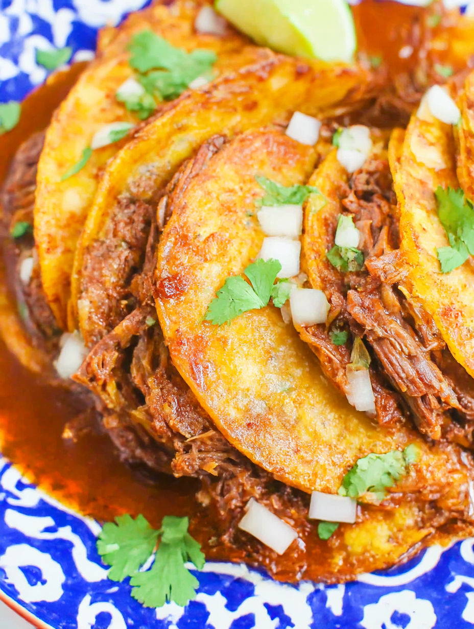 A plate of food with meat and onions.