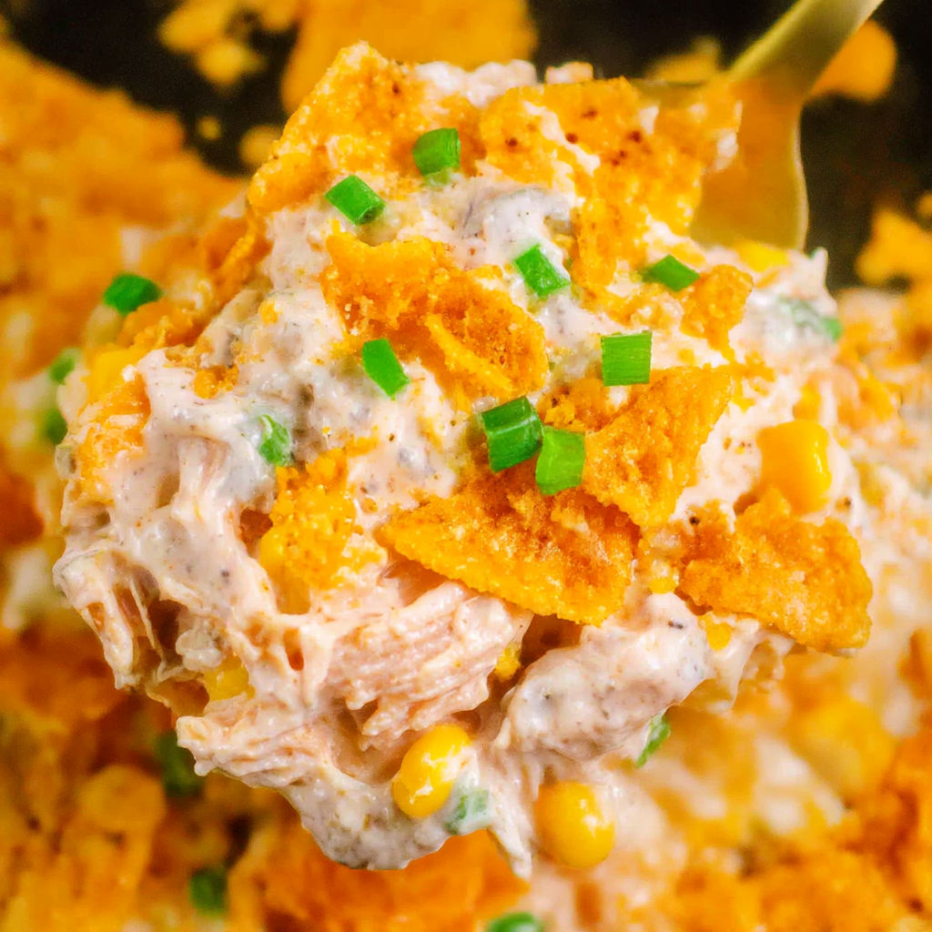 A bowl of food with a spoon in it.