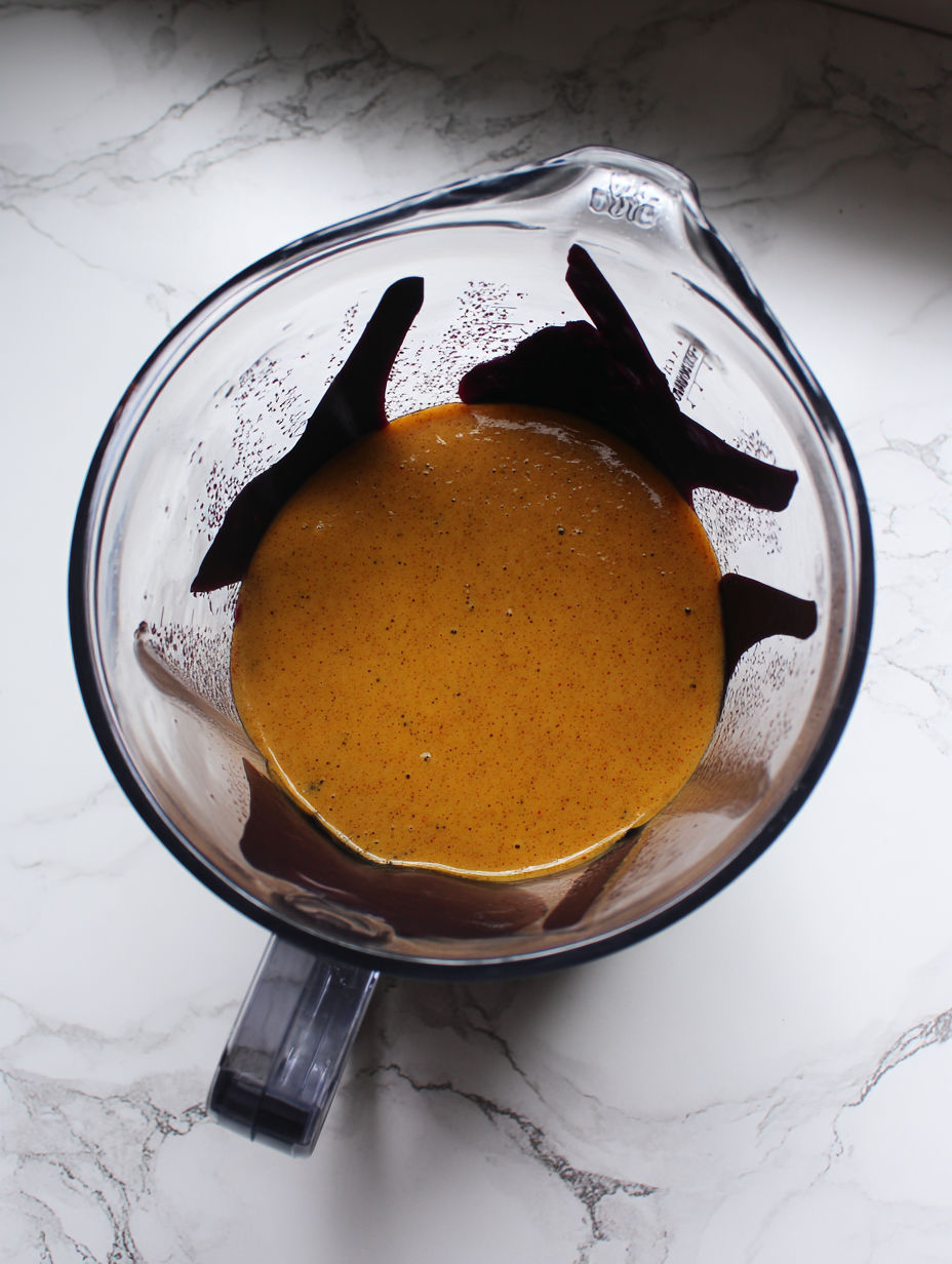 A blender with a liquid in it.