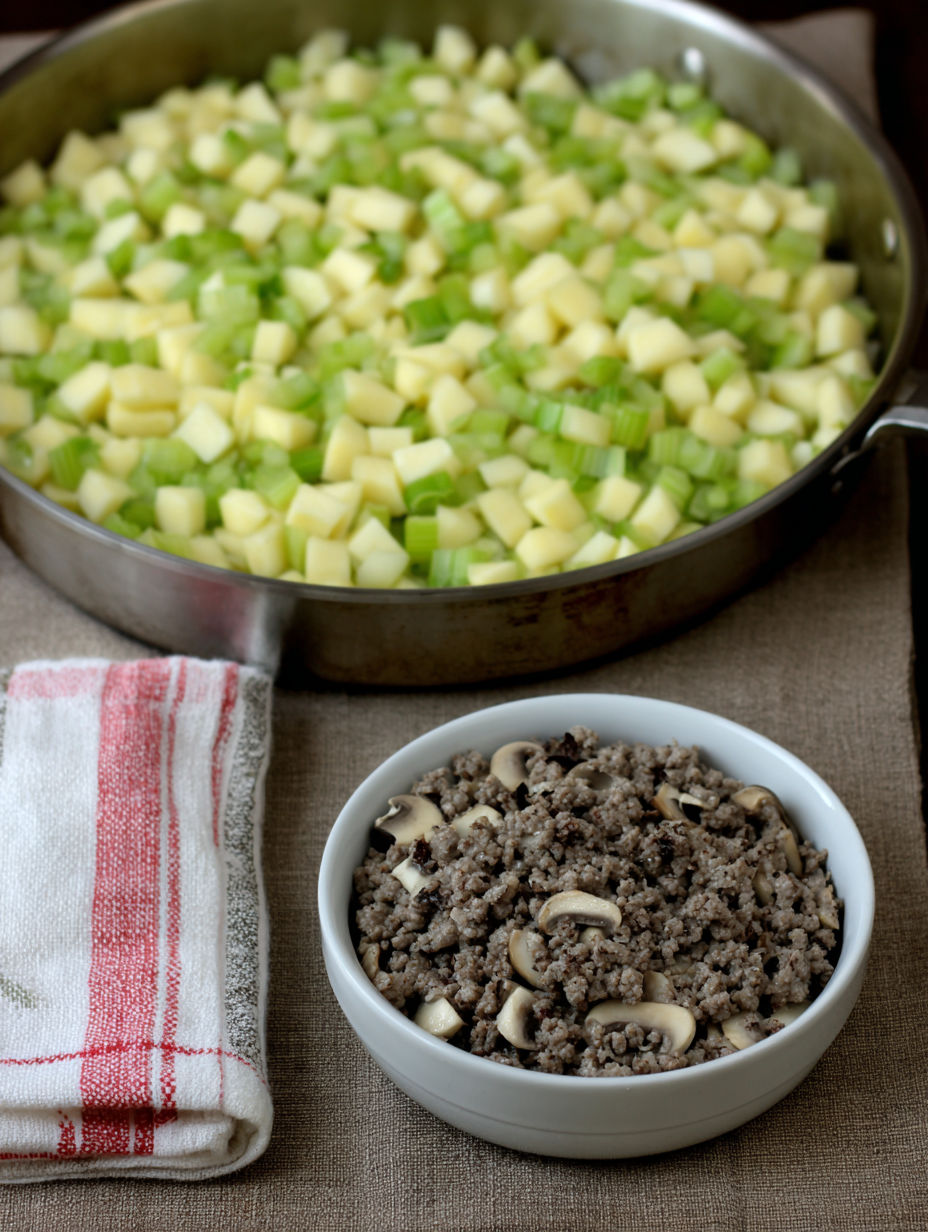 A bowl of mushrooms and a pan of vegetables.