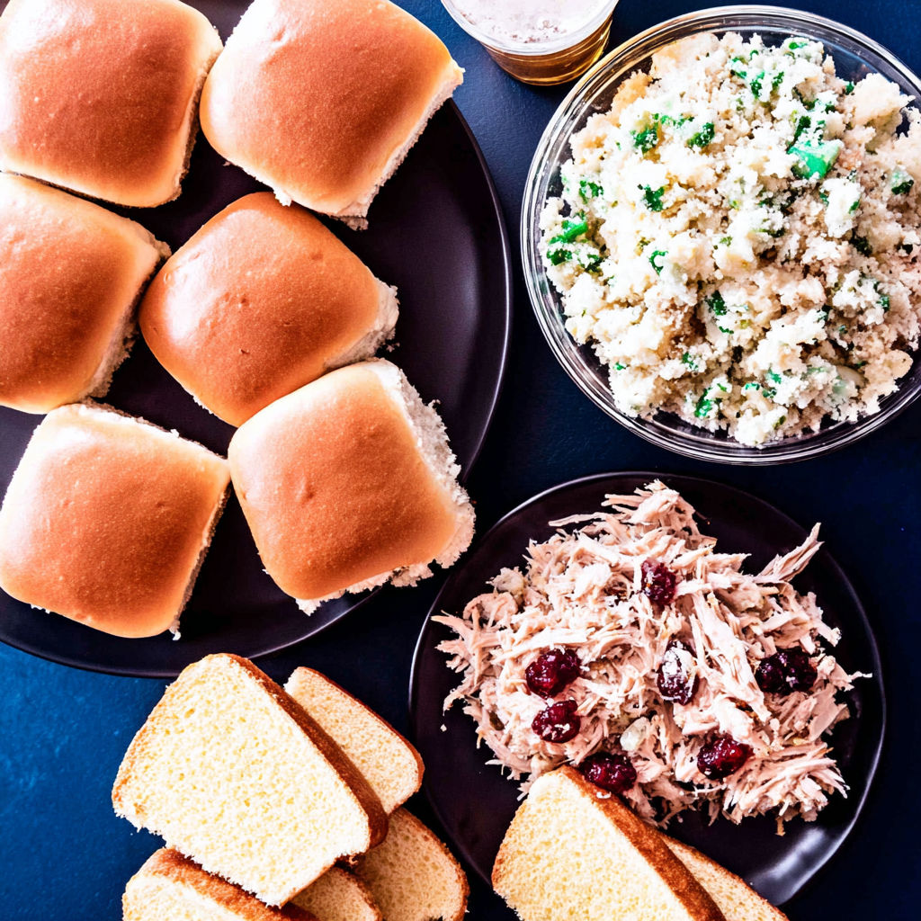 A table with a variety of foods including bread, rice, and meat.