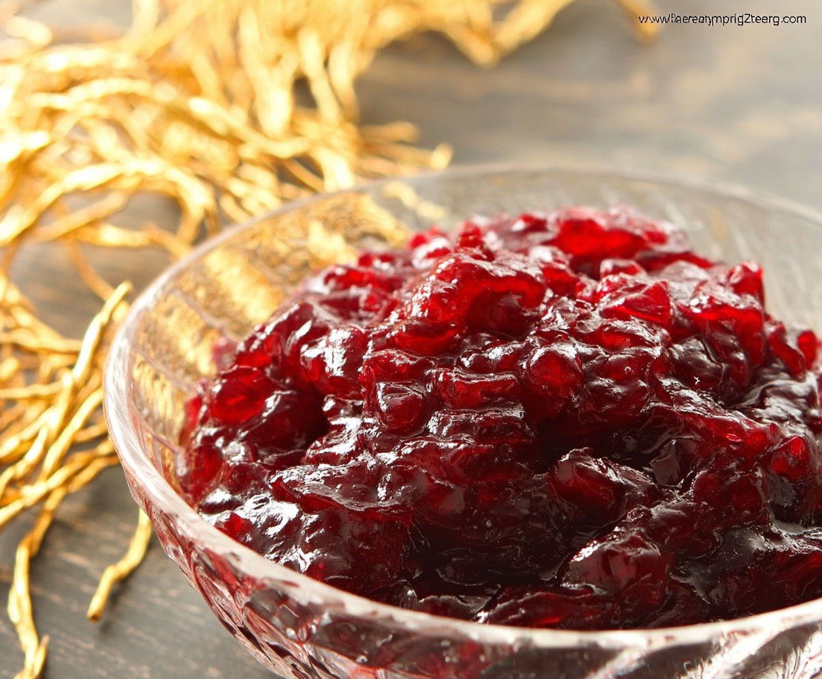 A bowl of red jello with gold foil.