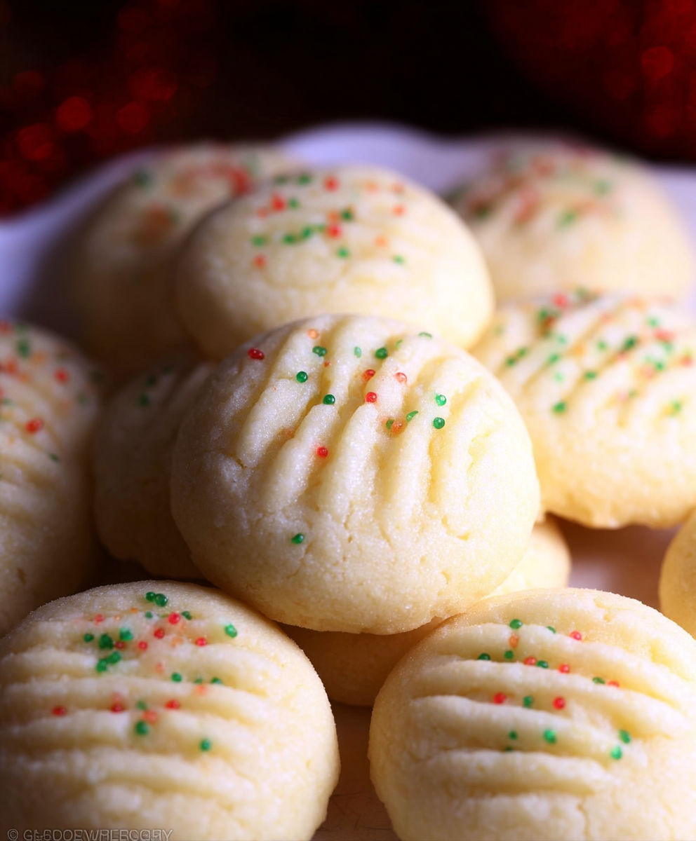 A plate of cookies with green and red sprinkles.