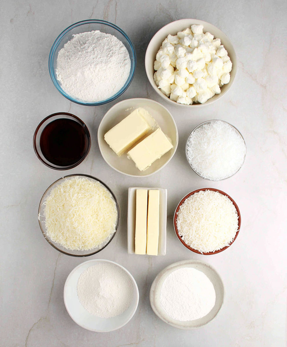 A table with various bowls of food, including butter and flour.