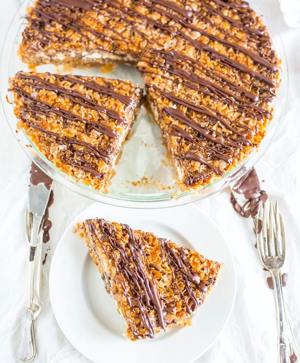 A slice of cake with chocolate and caramel toppings.