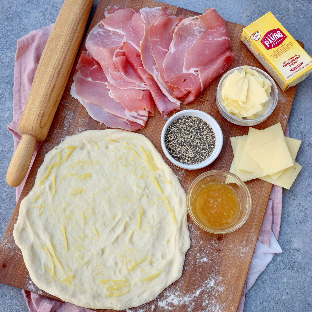 A wooden cutting board with various food items on it.