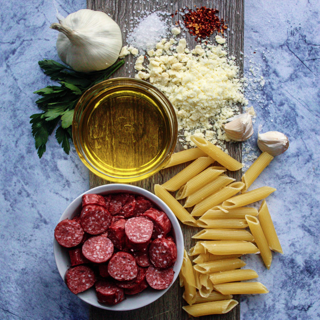 A bowl of pasta and a bowl of meat.