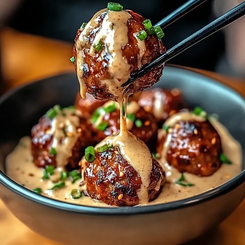 A bowl of food with chopsticks in it.
