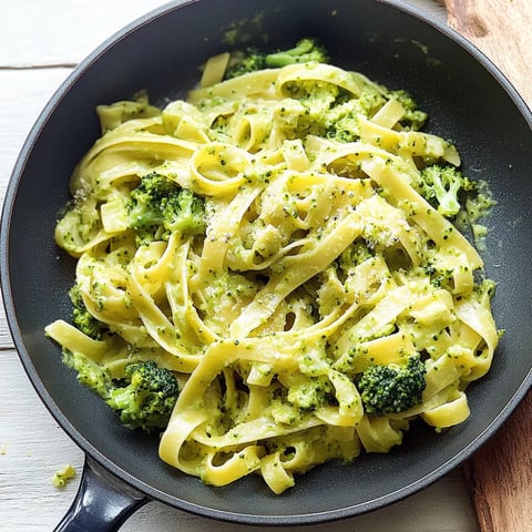 A bowl of pasta with broccoli.