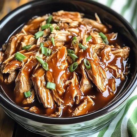 A bowl of meat with gravy.