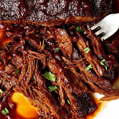 A piece of meat on a plate.