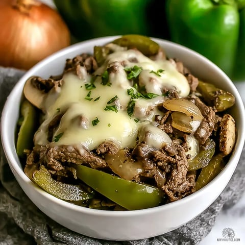 A bowl of food with meat and peppers.