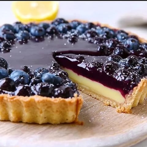 A slice of blueberry cheesecake on a plate.