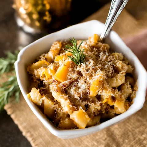 A bowl of pasta with cheese and herbs.