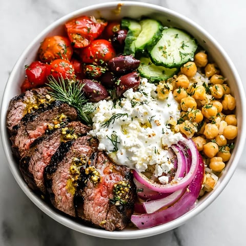 A bowl of food with meat, vegetables, and cheese.