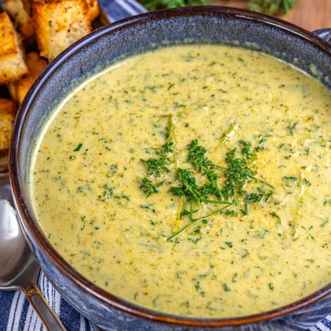 A bowl of soup with a spoon in it.