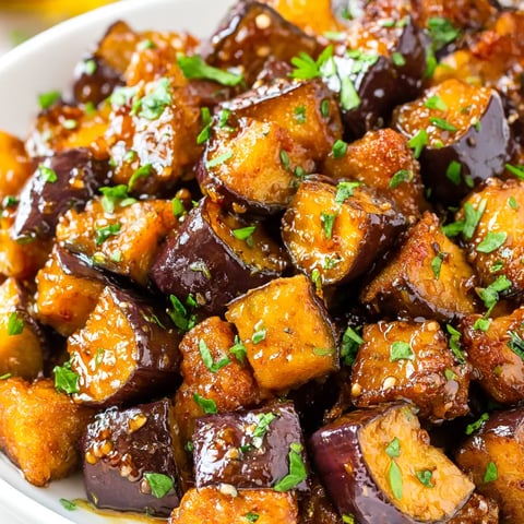 A bowl of food with a green garnish.