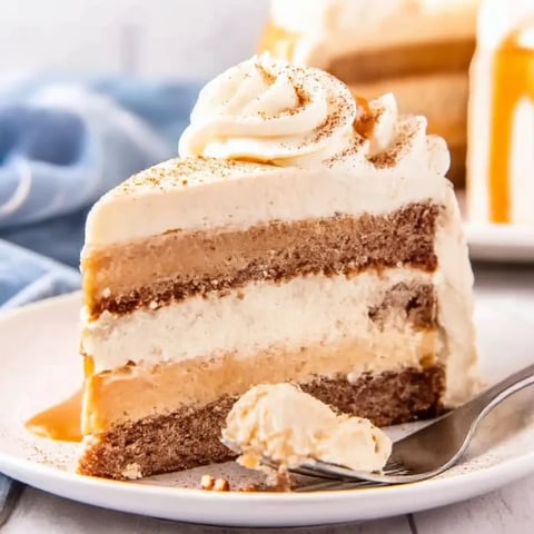 A slice of cake with whipped cream on a plate.