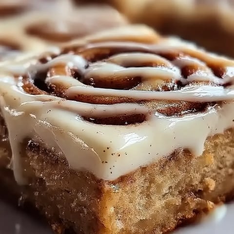 A piece of cake with icing on top.