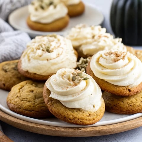 A plate of cookies with white frosting and cinnamon.