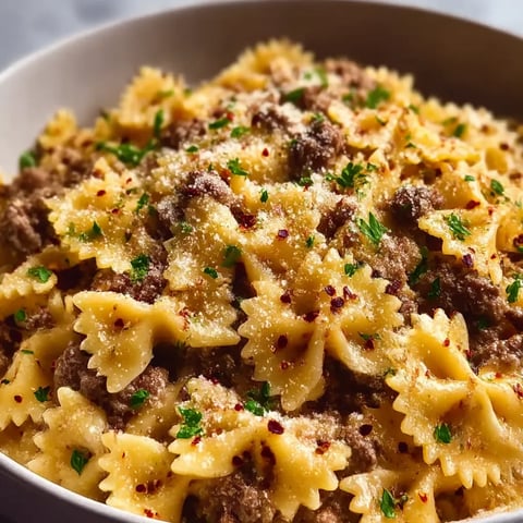 A bowl of pasta with meat and cheese.