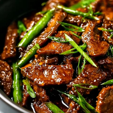 A bowl of beef and green beans.