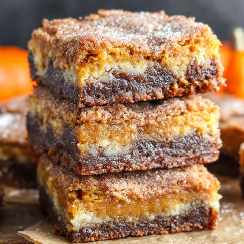 A stack of brownies with a white powder on top.