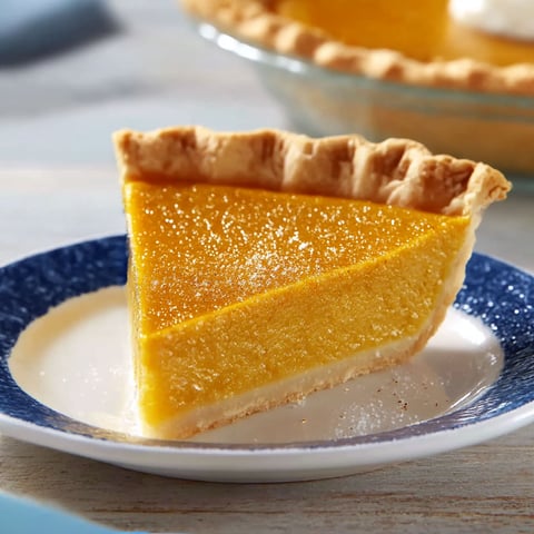 A slice of pumpkin pie on a plate.