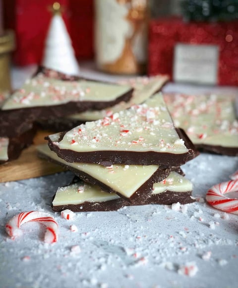 A close up of a chocolate dessert with white and red sprinkles.