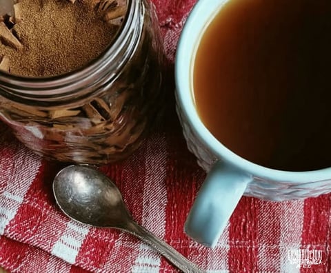 A cup of coffee with a spoon in it.