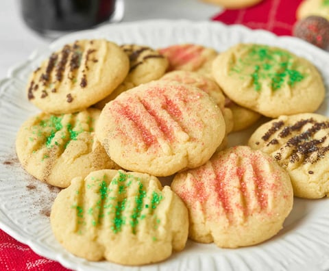 A plate of cookies with green and red sprinkles.