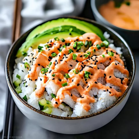 A bowl of rice with a spoon in it.